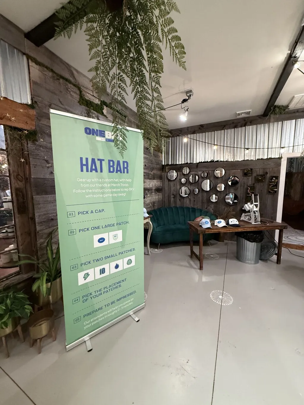 A Merch Troop hat-bar display with cap and patch selection instructions